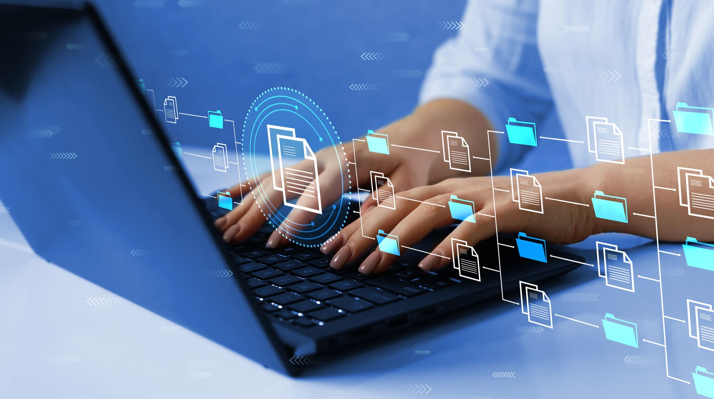 Close up of open laptop with a woman's hands typing.