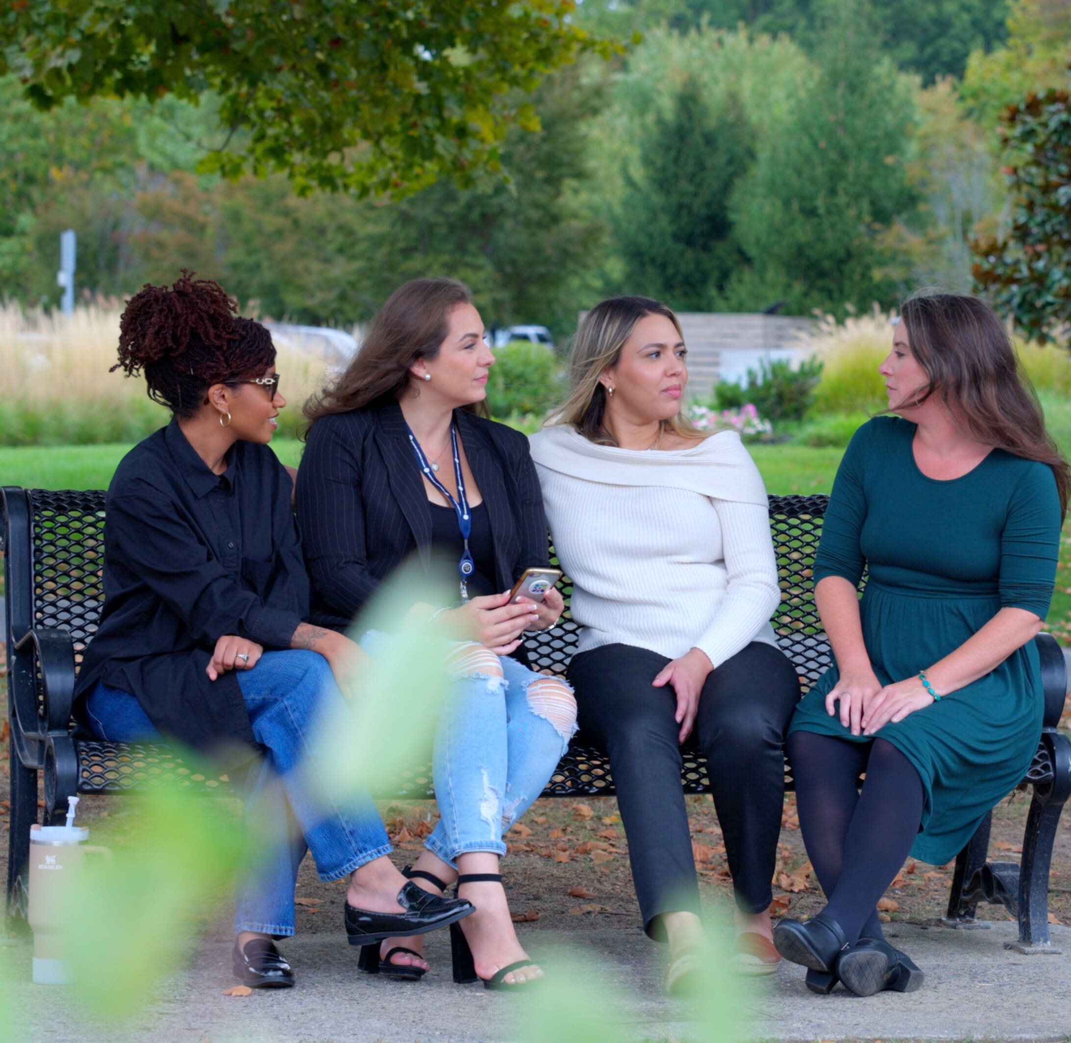 Power of New Jersey Birth Stories Liaisons sitting on a park bench at Cooper River Park